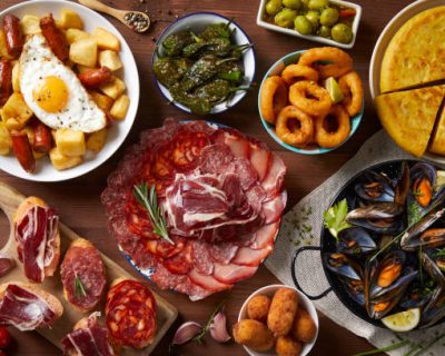 A table with typical Spanish food seen from above on a wooden table